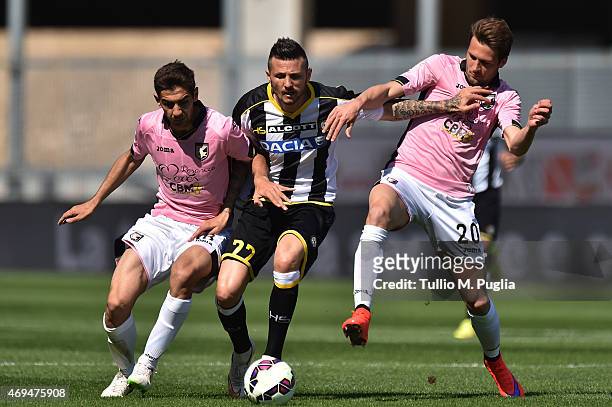 Cyril Thereau of Udinese is challenged by Ivajlo Chocev and Franco Vazquez during the Serie A match between Udinese Calcio and US Citta di Palermo at...