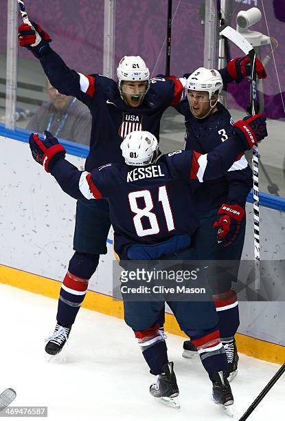 Cam Fowler of the United States celebrates with teammates James van Riemsdyk and Phil Kessel of the United States after scoring a goal against Sergei...