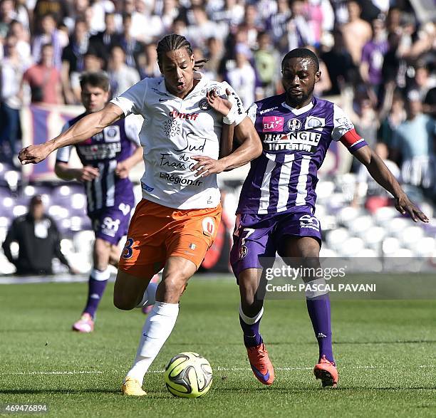 Toulouse's French Ivorian defender Jean Akpa-Akpro vies with Montpellier's French defender Daniel Congre during the French L1 football match Toulouse...