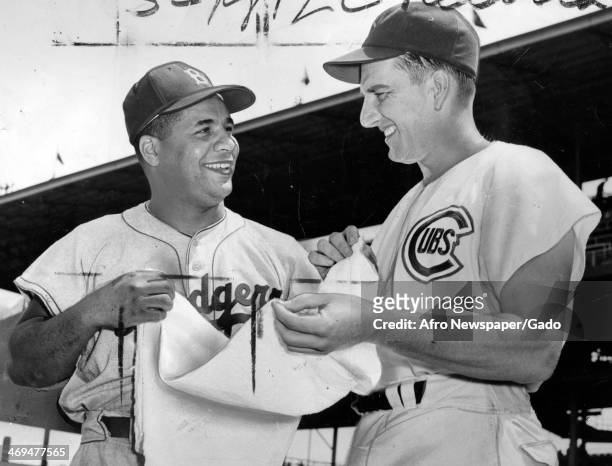 Roy Campanella, catcher for the Brooklyn Dodgers, talks with a baseball player for the Chicago Cubs, 1940.