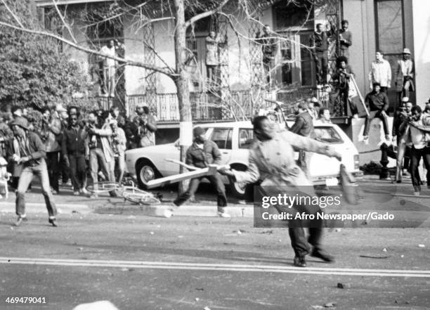 People hurling boards and bricks during the Anti Klan, anti racist protest in Washington DC, Washington, DC, November 27, 1982.