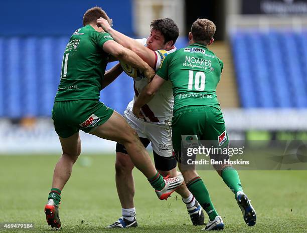 Marc Jones of Sale is tackled by Alex Lewington and Chris Noakes of London Irish during the Aviva Premiership match between London Irish and Sale...