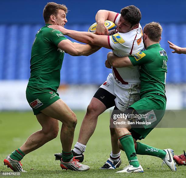Marc Jones of Sale is tackled by Alex Lewington and Chris Noakes of London Irish during the Aviva Premiership match between London Irish and Sale...
