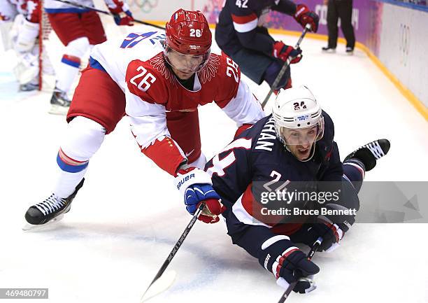 Ryan Callahan of the United States falls to the ice after tangling with Vyacheslav Voynov of Russia during the Men's Ice Hockey Preliminary Round...