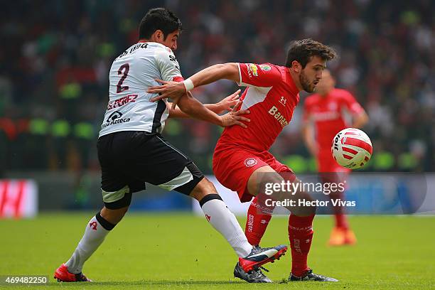 Enrique Perez of Atlas struggles for the ball with Jeronimo Amione of Toluca during a match between Toluca and Atlas as part of 13th round Clausura...