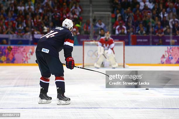 Oshie of the United States scores on a shootout against Sergei Bobrovski of Russia during the Men's Ice Hockey Preliminary Round Group A game on day...