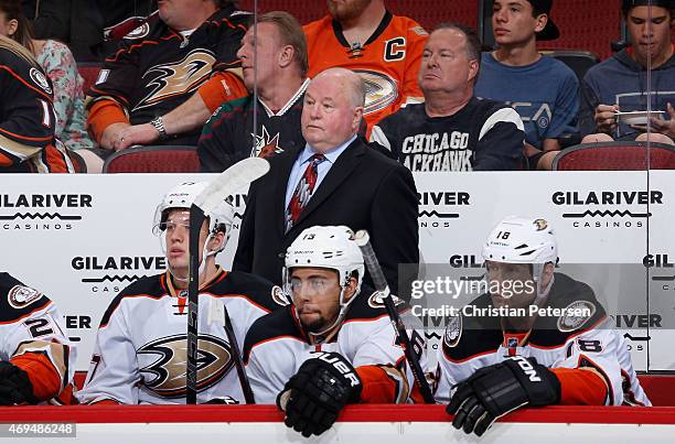 Head coach Bruce Boudreau of the Anaheim Ducks watches from the bench during the first period of the NHL game against the Arizona Coyotes at Gila...