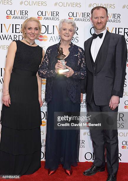 Amanda Abbington, Dame Angela Lansbury, winner of the Best Actress in a Supporting Role for "Blithe Spirit", and Mark Gatiss pose in the winners room...