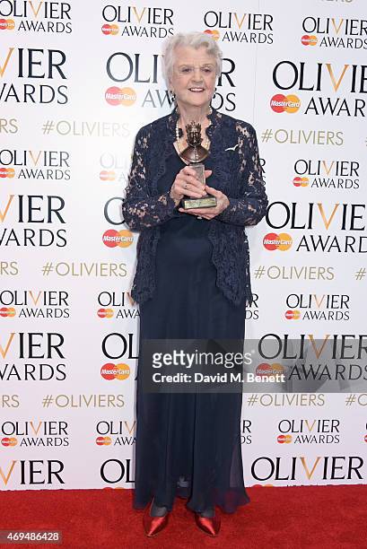 Dame Angela Lansbury, winner of the Best Actress in a Supporting Role for "Blithe Spirit" poses in the winners room at The Olivier Awards at The...