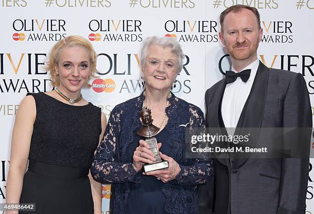 Amanda Abbington, Dame Angela Lansbury, winner of the Best Actress in a Supporting Role for "Blithe Spirit", and Mark Gatiss pose in the winners room...