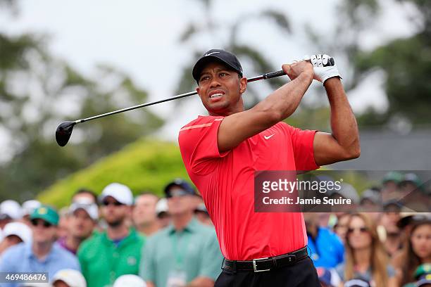 Tiger Woods of the United States watches his tee shot on the first hole during the final round of the 2015 Masters Tournament at Augusta National...