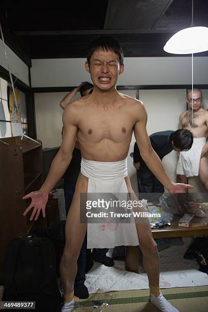 With the help of a friend this man dons a loincloth in order to participate in the Hadaka Matsuri, or Naked Festival at Saidaiji Temple on February...