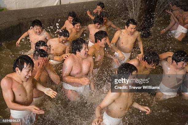 Men in loincloths purify themselves in a cold fountain as part of the Hadaka Matsuri, or Naked Festival at Saidaiji Temple on February 15, 2014 in...