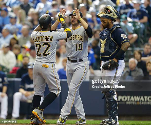 Andrew McCutchen of the Pittsburgh Pirates and Jordy Mercer of the Pirates high-five after McCutchen's three run home run in the fifth inning at...
