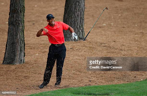 Tiger Woods of the United States reacts to a shot from the pine straw on the ninth hole during the final round of the 2015 Masters Tournament at...