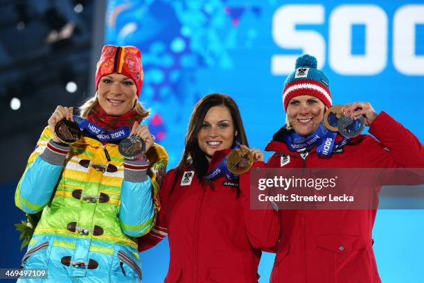 Silver medalist Maria Hoefl-Riesch of Germany, gold medalist Anna Fenninger of Austria and bronze medalist Nicole Hosp of Austria on the podium...