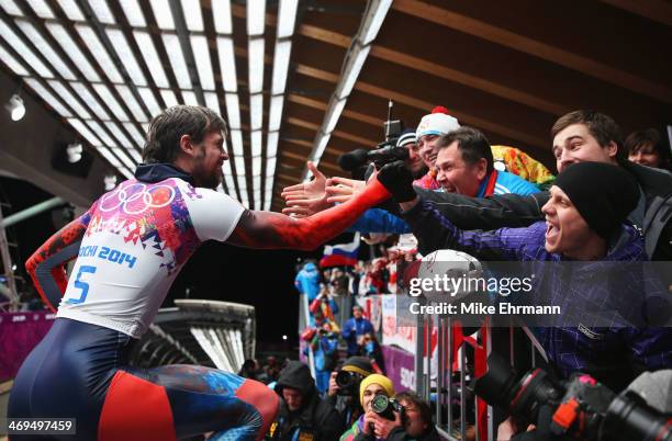 Alexander Tretiakov of Russia celebrates winning gold after his run during the Men's Skeleton on Day 8 of the Sochi 2014 Winter Olympics at Sliding...