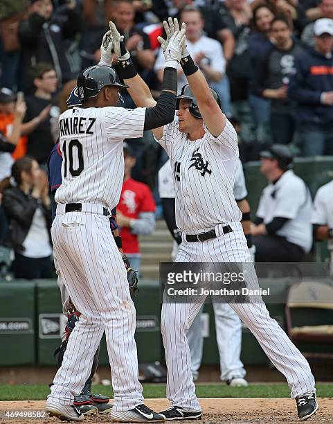 Alexei Ramirez of the Chicago White Sox high fives teammate Gordon Beckham after Beckham hit a two run home run in the8th inning against the...