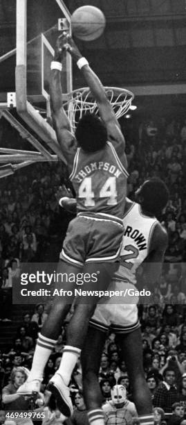 David Thompson, basketball player for the Seattle Sonics, jumps up to the basketball net, 1982.