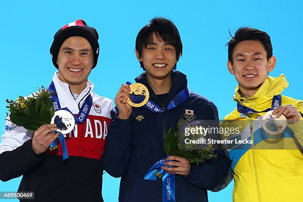 Silver medalist Patrick Chan of Canada, gold medalist Yuzuru Hanyu of Japan and bronze medalist Denis Ten of Kazakhstan on the podium during the...