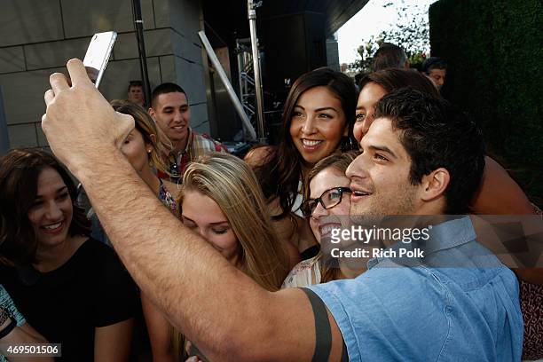 Actor Tyler Posey poses for a selfie photo with fans at The 2015 MTV Movie Awards at Nokia Theatre L.A. Live on April 12, 2015 in Los Angeles,...