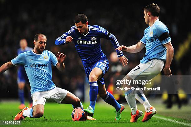 Eden Hazard of Chelsea holds off the challenge of Pablo Zabaleta and James Milner of Manchester City during the FA Cup Fifth Round match between...