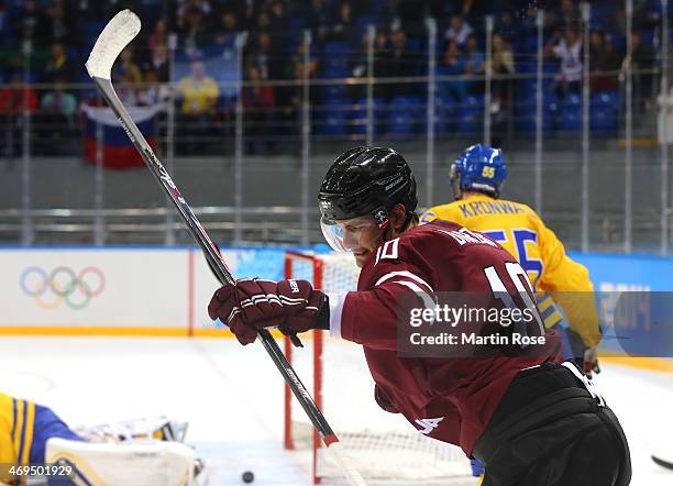 Lauris Darzins of Latvia celebrates after a goal in the first period against Sweden during the Men's Ice Hockey Preliminary Round Group C game on day...