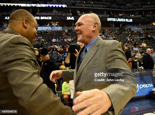 Former Denver Nuggets George Karl, now head coach for the Sacramento Kings gets a hug from Denver Nuggets head coach Melvin Hunt April 12, 2015 at...