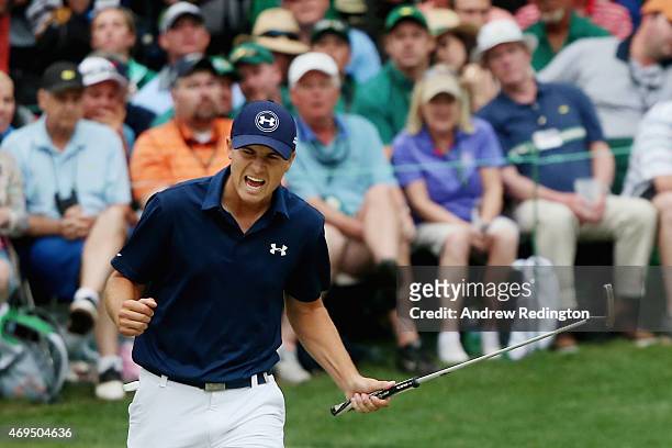 Jordan Spieth of the United States reacts to a par-saving putt on the 16th green during the final round of the 2015 Masters Tournament at Augusta...