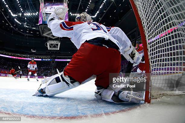Ondrej Pavelec of the Czech Republic gives up a goal to Simon Bodenmann of Switzerland in the first period during the Men's Ice Hockey Preliminary...