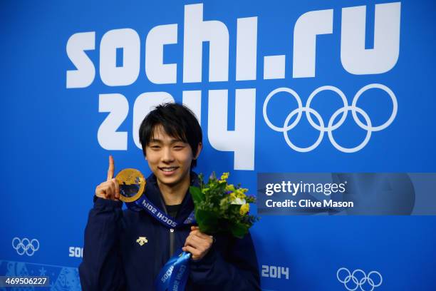 Gold medalist Yuzuru Hanyu of Japan celebrates during the medal ceremony for the Men's Figure Skating on day 8 of the Sochi 2014 Winter Olympics at...