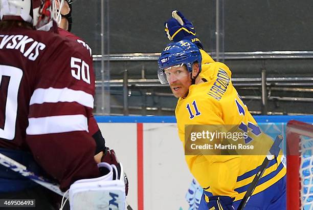 Daniel Alfredsson of Sweden celebrates after scoring against Kristers Gudlevskis of Latvia in the second period during the Men's Ice Hockey...