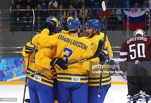 Jimmie Ericsson of Sweden celebrates with teammates after scoring against Kristers Gudlevskis of Latvia in the second period during the Men's Ice...