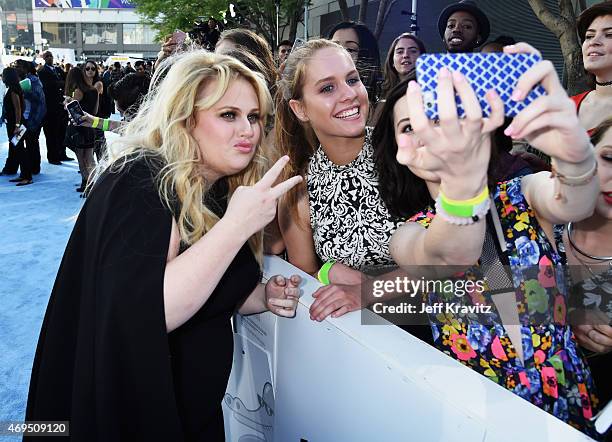 Actress Rebel Wilson takes pictures with fans on the red carpet at The 2015 MTV Movie Awards at Nokia Theatre L.A. Live on April 12, 2015 in Los...