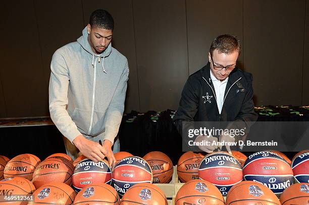 Anthony Davis and Scott Brooks of the Western Conference All-Stars autographs balls before NBA All-Star Practice at Sprint Arena as part of 2014 NBA...