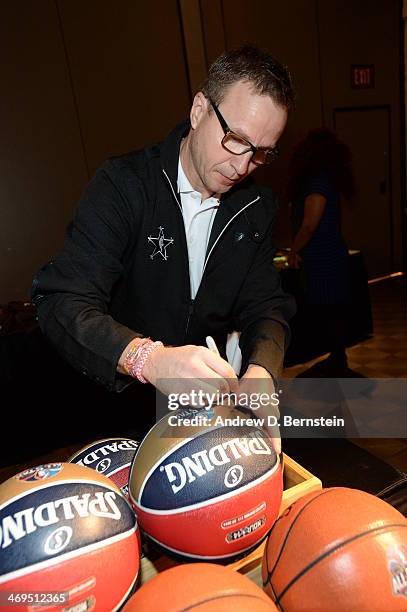 Head Coach Scott Brooks of the Western Conference All-Stars autographs balls before NBA All-Star Practice at Sprint Arena as part of 2014 NBA...