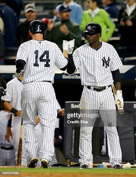 Didi Gregorius of the New York Yankees congratulates Stephen Drew after Drew hit a solo home run in the first inning against the Boston Red Sox on...