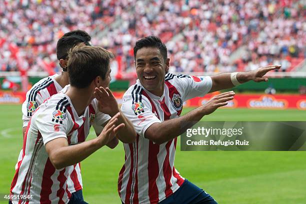 Marco Fabian de la Mora of Chivas celebrates with teammates after scoring the first goal of the game, during a match between Chivas and Leon as part...