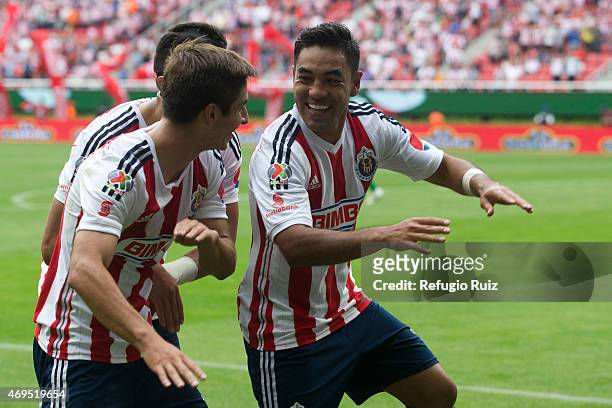 Marco Fabian de la Mora of Chivas celebrates with teammates after scoring the opening goal during a match between Chivas and Leon as part of 13th...