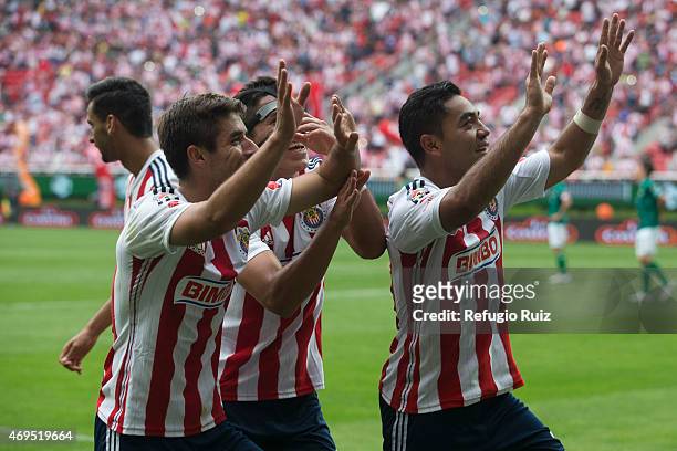 Marco Fabian de la Mora of Chivas celebrates with teammates after scoring the opening goal during a match between Chivas and Leon as part of 13th...