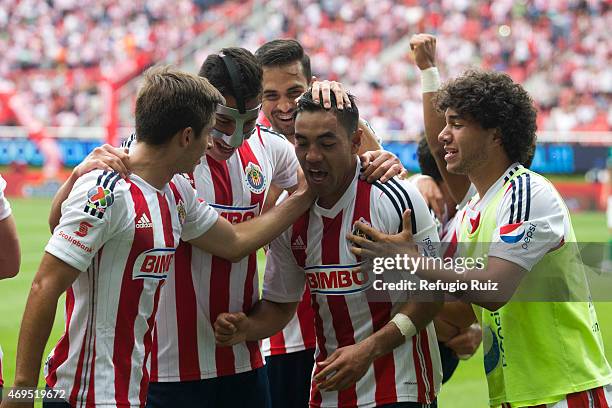 Marco Fabian de la Mora of Chivas celebrates with teammates after scoring the opening goal during a match between Chivas and Leon as part of 13th...