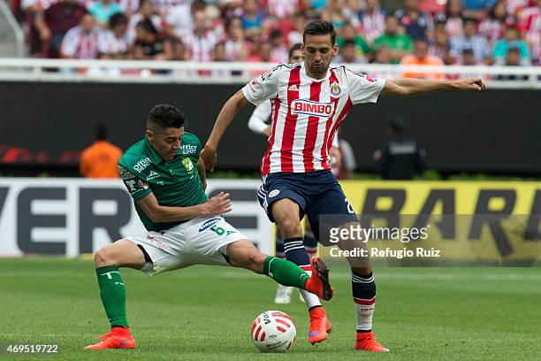 Raul Lopez of Chivas, fights for the ball with Jose Maria Cardenas of Leon during a match between Chivas and Leon as part of 13th round of Clausura...