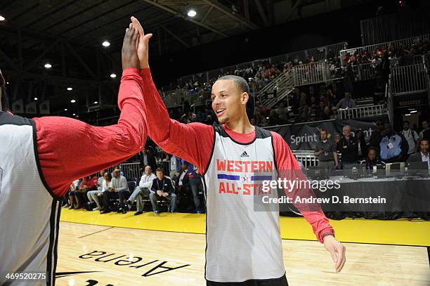 Stephen Curry of the Western Conference All-Stars hi fives a teammate during NBA All-Star Practice at Sprint Arena as part of 2014 NBA All-Star...