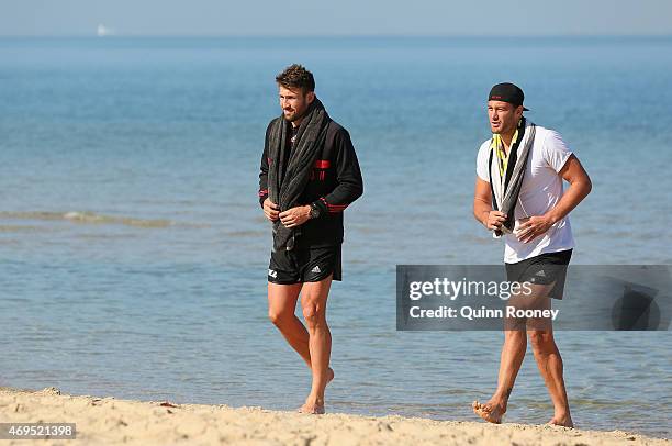 Cale Hooker and Tom Bellchambers of the Bombers walk out of the water during an Essendon Bombers AFL recovery session at Port Melbourne Life Saving...