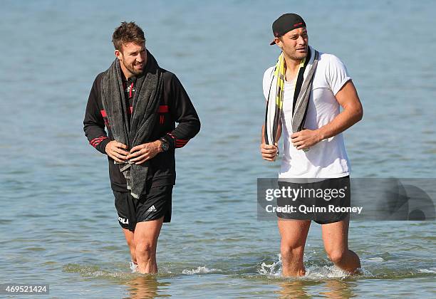 Cale Hooker and Tom Bellchambers of the Bombers walk out of the water during an Essendon Bombers AFL recovery session at Port Melbourne Life Saving...