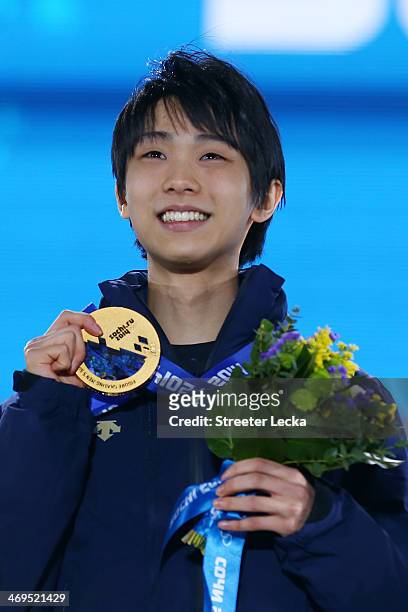 Gold medalist Yuzuru Hanyu of Japan celebrates on the podium during the medal ceremony for the Men's Figure Skating on day 8 of the Sochi 2014 Winter...