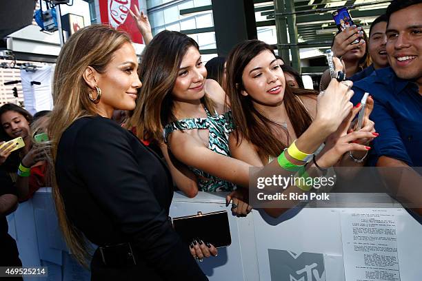 Actress/singer Jennifer Lopez poses for a selfie photo with fans at The 2015 MTV Movie Awards at Nokia Theatre L.A. Live on April 12, 2015 in Los...