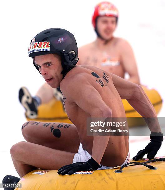 Male participants compete in the 2014 Naken Sledding World Championships on February 15, 2014 in Hecklingen, near Magdeburg, Germany. The annual...