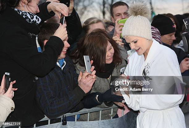 Melanie Mueller, winner of the German television program Dschjungelcamp , gives autographs to fans after her run in the 2014 Naken Sledding World...