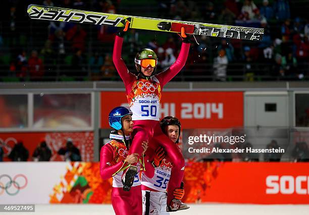 Gold medlaist Kamil Stoch of Poland is lifted on the shoulders of Maciej Kot of Poland and Jan Ziobro of Poland after the Men's Large Hill Individual...